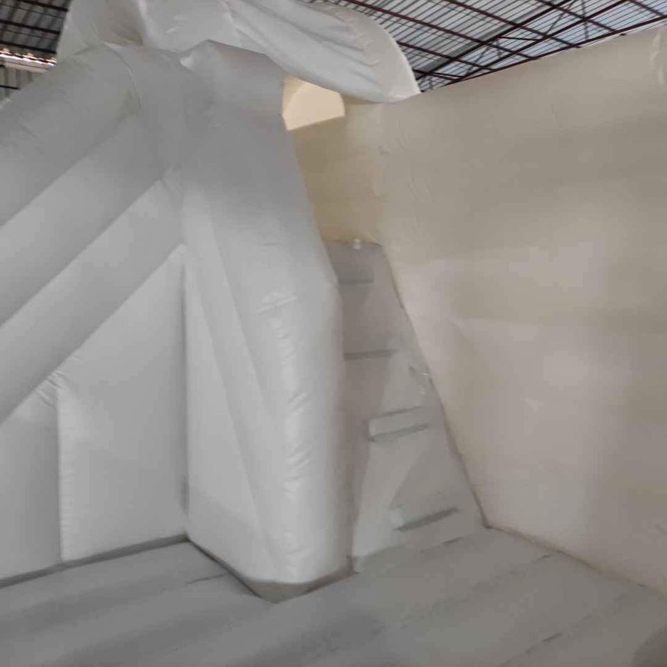 Large white bounce house with double slide