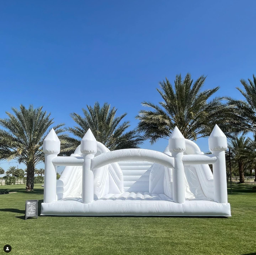 Large white bounce house with double slide